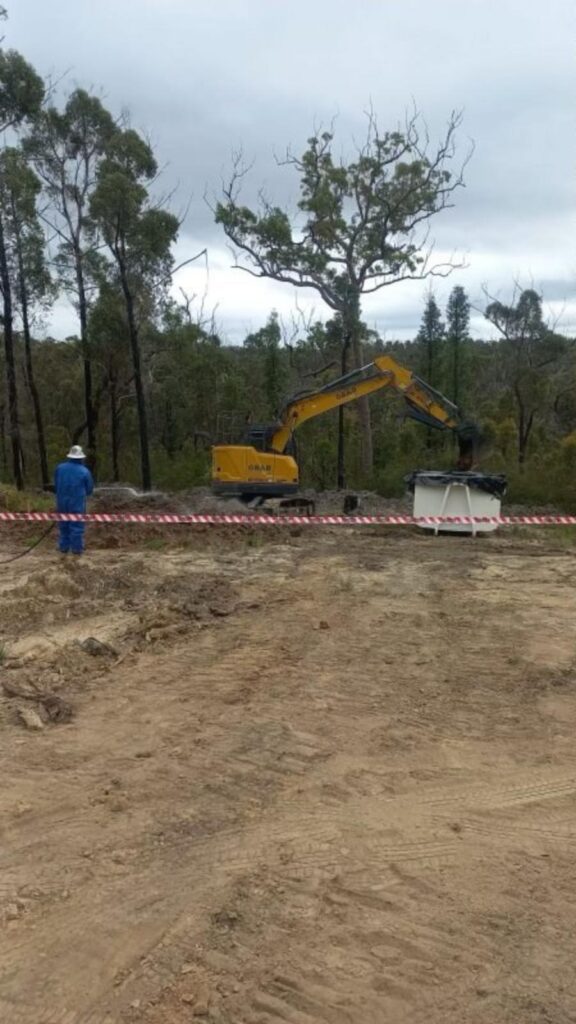 excavator keeping the land flat during Contaminated Land Remediation Australia